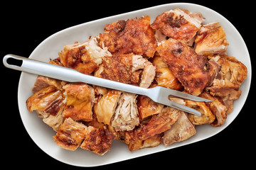 Freshly Spit Roasted Pork Thigh Meat Slices Offered on Oblong Porcelain Tray with Serving Fork Isolated on Black Background