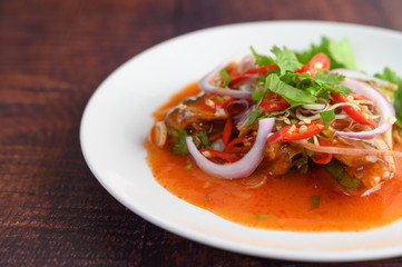 Spicy salad of sardine with tomato sauce in white dish