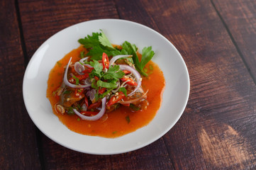 Spicy salad of sardine with tomato sauce in white dish