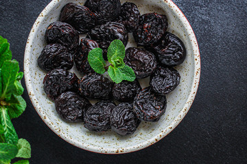 prunes, dried plums (tasty and healthy fruits) menu concept. background. top view. copy space