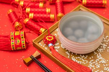 Chinese Lantern Festival traditional food black sesame dumplings on red background