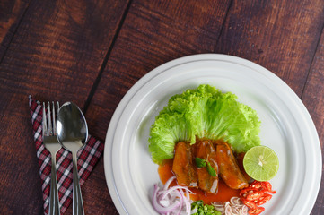 Spicy salad of sardine with tomato sauce in white dish