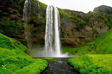 Beautiful view of the tall waterfall of Seljalandsfoss, Iceland in the summer