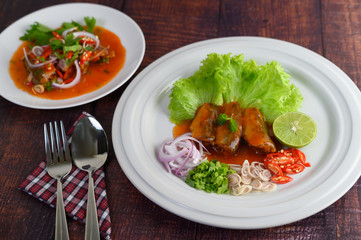 Spicy salad of sardine with tomato sauce in white dish