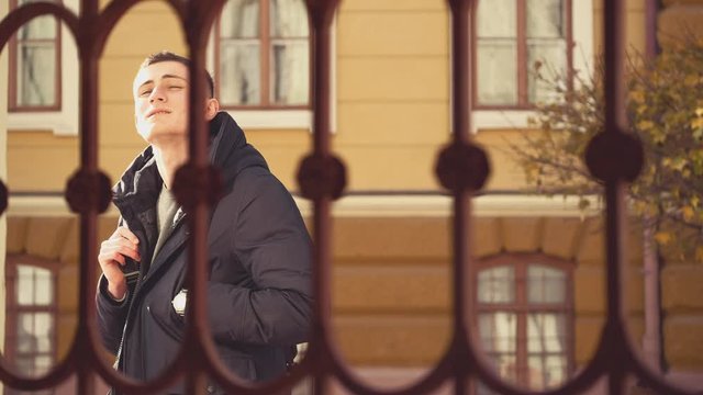 Handsome men feets is passing by the yellow building. Thoughtful guy. Urban Environment. Cropped. Action. Animation. 4K.