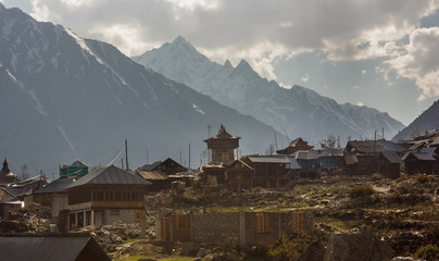 The ancient wooden temple and the houses of the Chitkul village set against the backdrop of the...