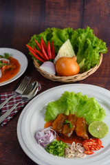 Spicy salad of sardine with tomato sauce in white dish
