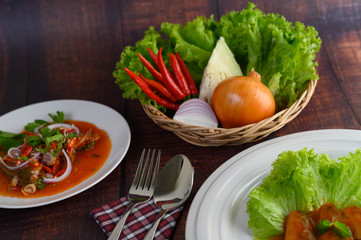 Spicy salad of sardine with tomato sauce in white dish