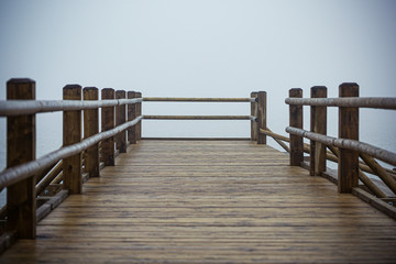 not a big wooden bridge on the lake with heavy fog