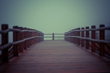 not a big wooden bridge on the lake with heavy fog