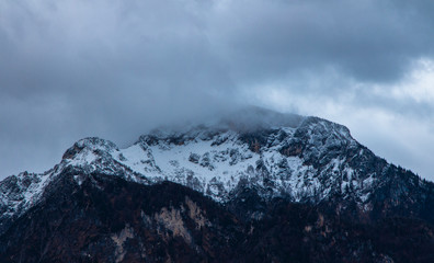 winter time snowy lonely mountain peak gorgeous picturesque moody and foggy scenic view landscape...
