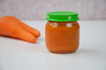 baby food, baby mashed in a glass jar, sliced carrot