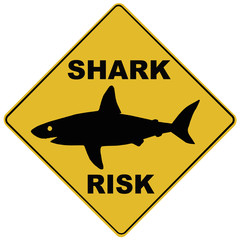 a signboard that says : SHARK RISK