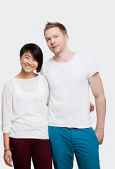 Obraz premium Portrait of young couple in casuals smiling over white background