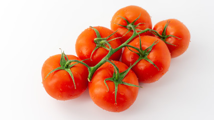 Grape of red tomatoes on a white background. Isolated