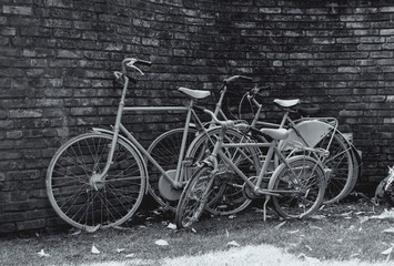 Fototapeta na wymiar three bikes in front of a stone wall