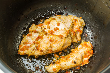 Beautiful chicken breast fillet marinated in hot spices cooked roasted in slow cooker.