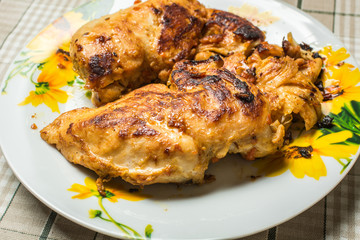 Fresh fried chicken breast fillet in a plate on the kitchen table.