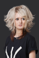 Young woman with modern hairstyle over black background