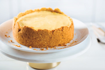 Cheesecake on the stand on white background