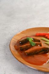 Appetizers salad of sardine in tomato sauce on wooden tray