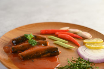 Appetizers salad of sardine in tomato sauce on wooden tray