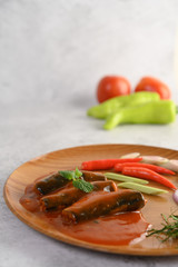 Appetizers salad of sardine in tomato sauce on wooden tray