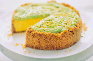 Homemade pistachio Cheesecake on white plate