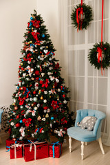 Beautiful Christmas tree decorated with toys and gift boxes
