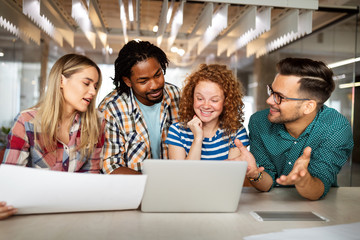 Successful group of designers, business people at work in office