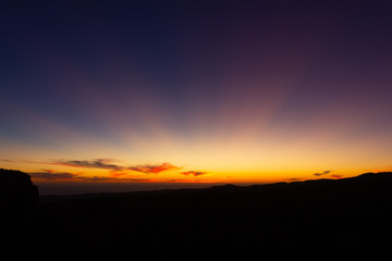 Obraz premium Bright sun rays over blue purple sky at sunset in Gran Canaria, Spain. Colorful twilight in Canary Islands. Natural landscape concept