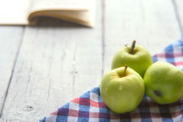 .apple background. On a white wooden table. In a rustic style. Books