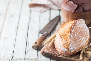 Freshly baked homemade traditional bread on rustic wooden table