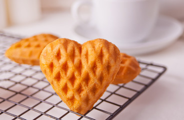 Heart shaped cookies on the baking rack.