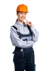 pretty cute builder girl in uniform and helmet . Isolated