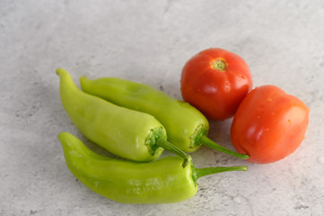 Green peppers and fresh tomato on white background