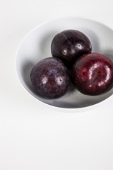 Close-up of plums in bowl