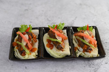 The spicy sardine in ceramic tray