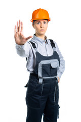 girl in orange helmet shows hand stop sign. Isolated