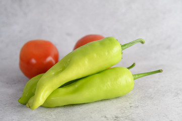 Green peppers and fresh tomato on white background