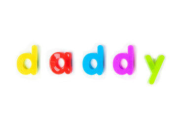 Colorful alphabet magnets spell 'daddy' over white background