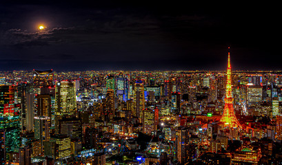 Fototapeta na wymiar Panorama of the modern city with lighting of architecture building under night skyline and light full moon and cloud in Tokyo city, Japan.