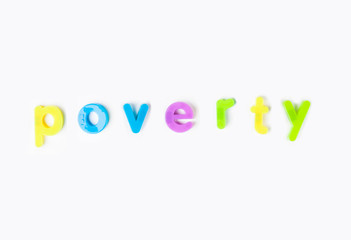 Poverty' spelled with colorful alphabet magnets over white background