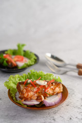 Appetizing Spicy Canned Sardine salad with spicy sauce in wood bowl