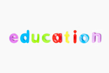 Education' spelled with colorful alphabet magnets over white background