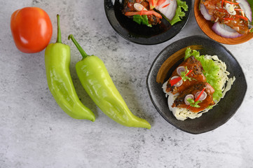 Appetizing Spicy Canned Sardine in spicy sauce in black ceramic bowl