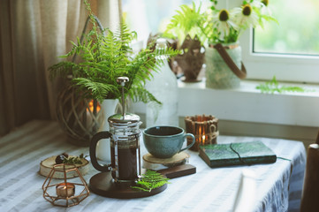 summer morning at wooden cottage kitchen with coffee and wild ferns in vase