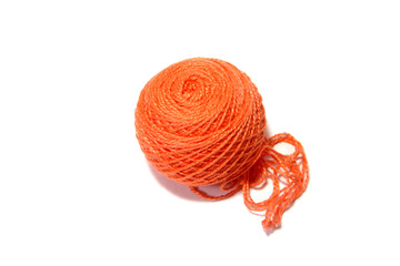 Ball of orange string on a white background.         