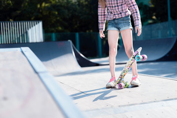 teenage girl performing a trick with a skateboard on the sports field