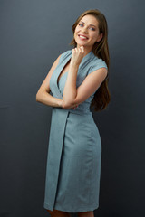 young woman in offise dress with big toothy smile.